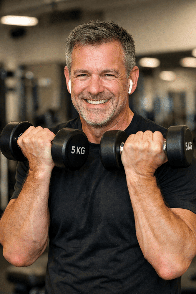 Man at the gym carrying dumbells